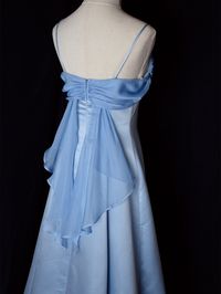 Step into timeless elegance with this Vintage Blue Satin Gown. Crafted from luxurious satin, this dress features delicate spaghetti straps that provide a graceful and feminine silhouette. The highlight of this gown is its unique winged back design, adding a touch of whimsy and sophistication. Perfect for formal occasions, evening events, or any special celebration, this elegant dress ensures you'll make a stunning entrance. The vintage blue hue adds a classic touch, making it a versatile additio