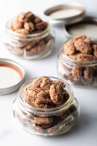 How to Make Candied Pecans - This easy recipe bakes up perfectly salty, sweet, and crunchy candy-coated pecan halves with only a handful of simple ingredients. These cinnamon sugar pecans are delightful for snacking, and make great holiday gifts!