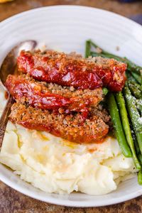 Amazing homemade Meatloaf Recipe. The meatloaf is so tender and juicy on the inside with a sweet and tangy sauce that glazes the meatloaf and adds so much flavor! #meatloaf #meatloafrecipe #howtomakemeatloaf #glazedmeatloaf #meatloafsauce #bestmeatloaf #natashaskitchen #groundbeef