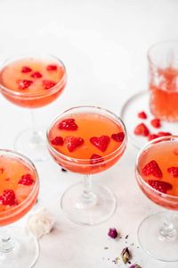 This Strawberry Vanilla Vodka Cocktail is the perfect Valentine's Day drink! It's fruity, sweet (but not too sweet), and the most gorgeous, festive pink hue. Heart-shaped strawberry garnish optional, but encouraged! #valentinesdaycocktail #vday #valentinesdayrecipes #strawberryvodkacocktail #vodkacocktail #cocktailrecipes | crowdedkitchen.com