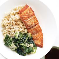 Nutritious salmon, whole grains, and a side of greens will fill you up with the good stuff.