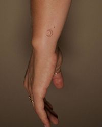 Tattoo Artist: Ivo. Tags: categories, Minimalist, Line Art, Fine Line, Astrology, Planet Symbols, Moon Planetary Symbol, Last-Quarter Moon · Planet Symbols, Symbols, Astronomy, Moons, Crescent Moon. Body parts: Wrist.