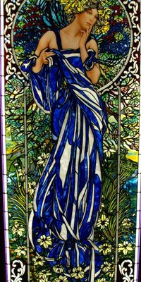 stained glass window by mark bogenrief | 266.7x111.8 | pendant to the champagne lady | 'here is our stained glass window based on alphonse mucha that we spiced up a bit | around 8,000 pieces made mostly of youghiogheny glass [sheet glass made for stained glass windows by a glass company in connelsvill, pennsylvania] | the art nouveau border is two pieces fused together to give an elliptical effect'