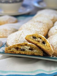 sweet panelle with ricotta filling cut in half on plate filled with more cookies