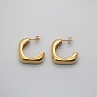 Esme is a pair of square hoop earrings that you should have to elevate your jewelry collection to another level. The finely polished gold plated surface is uttering the texture of delicacy and elegance.  18k gold plated Stainless steel base Water resistant, tarnish resistant Measures 28mm*28mm