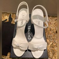 Hello!!! I Hope You Will Love These Shoes As Much As I Did When Purchasing Them! I Have Never Worn This Shoes Other Than For Pictures At My House For About 10 Mins For My Wedding Day!! These Are Brand New Chanel Bow White Sandal Heels!! I Bought These At The Wynn Las Vegas Chanel Boutique! They Are So Special To Me But They Are Too High For Me So I Want To Sell Them! If You Have Any Questions Please Let Me Know!! All Original Packaging Of The Box. These Are Perfect Shoe To Have In Your Collectio