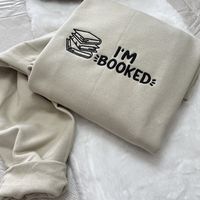 I'm Booked Embroidered Sweatshirt.  Hello there! Please message me if you have any additional questions or want to change thread colors. We are a family-run Etsy page; my husband and I make all orders from home. You can also send us a message if you would like a custom sweatshirt/t-shirt with whatever words and images, and we will see if we can accommodate your order! HOW TO ORDER - Please Choose the SIZE and COLOR From Drop Down Menu. MATERIAL - We use JerZees as our blanks; I may sometimes sub