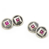 Jewellery Discovery - A pair of French, Art Deco, black onyx and ruby cufflinks, mounted in platinum, with square-cut rubies, in heavy, platinum, square settings, within discs of black onyx, in platinum surrounds, with French dog marks for platinum and numbered 25, with inventory marks, circa 1930.     	Style - Art Deco   	Metal - Platinum   	Stone - Ruby   	Condition - Good - Wear consistent with age