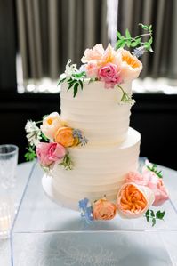 Two-tiered Wedding Cake with pink, orange, & blue florals.