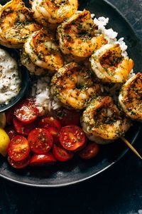 Saucy, punchy, and delightful Chimichurri Shrimp! Served with a tomato salad, a pile of hot steamy rice, and a dollop of creamy tzatziki.