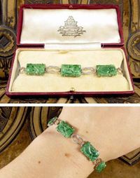 A gorgeous Antique Art Deco Carved Jade Link Bracelet. Featuring six panels of floral carved natural jade with white gold links between. Comes in original antique box. #jade #jadebracelet #naturaljade #carvedjade #artdecobracelet #artdecojewellery