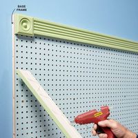 Dress It Up - Most pegboard comes in two colors�boring white and boring brown. But it doesn't have to stay that way. Roll on a coat of primer followed by gloss or semigloss paint (glossy paints are easier to wipe clean). Apply light coats so you don't clog the holes. Then snazz it up with a frame. After we attached our pegboard to a 1x3 frame, we added corner blocks and trim with hot-melt glue�no fancy miter cuts or fasteners needed.