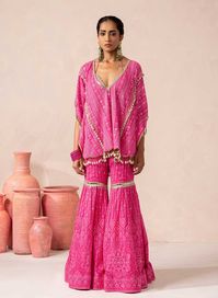 - Thread and mirror work Embroidered Georgette - Silver gota detail on the neck and sharara. - Shell hangings on the kaftaan. Look Pretty in Pink with our Aria Sharara Set. Crafted with intricate self-thread embroidery, this stunning ensemble exudes a regal charm. The vibrant fuchsia pink hue adds a pop of colour to yo