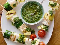 Tired of lackluster reactions to the phrase "dinner's ready"? Try a trick I use on my brood and serve skewers. From sides to entrees, everything's more festive on a stick, and the good news is, it's pretty simple too. 1. Fish Skewers with Basil Chimichurri (pictured above): With bright pops of green basil sauce and juicy red cherry tomatoes, Melissa d'Arabian's skewers turn fish from a picky eater's no-no into a showstopper worth trying. 2. Pork and Pineapple Kebabs: Sure a pork chop is tasty...