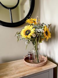 Bring a touch of nature into your home with this Artificial Flower Bouquet,  featuring sunflowers, delicate gypsophilia, eucalyptus, and a mix of lush foliage.     Designed to enhance any space, this versatile bouquet is perfect for year-round decor. Whether you're styling a cozy country home or adding charm to your cottage-inspired decor, this arrangement brings a natural, timeless beauty to any room.  ⬆️ Dimensions ⬆️ Arrangement is 50cm/20inch tall Clear vase is 20cm/8inch tall ♻️Packaging  ♻