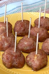 Ham Balls with toothpicks for a party appetizer on a yellow plate