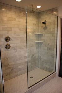 Walk-in shower with knobs away from the shower head.