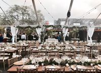 This beautiful Miami wedding during winter time featured a mix of farm tables, gold Chiavari chairs and the perfect clear top tent #miamiwedding #cleartent #wywoodwedding #farmtables #chiavarichairs