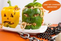 Pasta-stuffed peppers cut into jack-o-lanterns. Made with raw zucchini or brown rice spaghetti and smothered in a 5 minute simple raw red sauce.