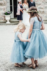 Flower girls wear blue dresses for a Whimsical and Romantic Walled Garden Wedding. Photography by Carley Buick