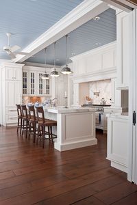 love the painted beadboard ceiling that ties in the marble and warms up the space.