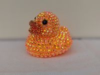 Orange rhinestone rubber duck made with AB rhinestones. A perfect gift for yourself or your favorite off-road enthusiast! Each rhinestone is hand placed. Duck is 2x2in. You may notice an odor coming from the duck. It is from the extra- strength glue used to place the rhinestones. Leave the duck in a well- ventilated area and the smell will dissipate in a few days. *If you plan to keep the duck in a vehicle, keep an eye on it when it is hot outside. Rubber ducks are known to melt or misshapen in