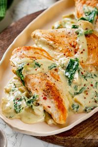 Creamy spinach artichoke chicken is a fast and easy one-pan dinner recipe brimming with briny artichokes, spinach, and lots of melty cheese. #spinachartichoke #chicken #chickendinner