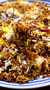 Adas polo is a traditional Persian rice and lentil recipe seasoned with cinnamon and saffron, layered with caramelized onions, raisins, and dates, and finished with a crispy tahdig layer. As pretty as it is delicious, this fragrant golden rice deserves center-stage on your dinner table!