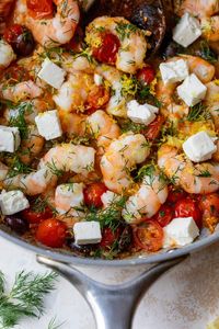 Classic Greek Shrimp Saganaki dish features shrimp simmered in a flavorful tomato sauce with briny olives and creamy feta. Perfect for a quick healthy dinner yet elegant enough for company. #shrimp #protein #mediterranean #dinner #quickdinner #easyrecipe #healthyrecipe #healthydinnerrecipe