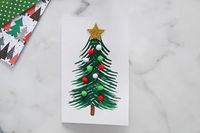 Learn how to make your own fork painted Christmas tree! This is so easy for kids to make their own Christmas card.