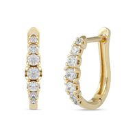 Add sparkle to most any attire with these chic journey diamond huggie hoop earrings. Created in warm 10K gold, each timeless hoop showcases a row of diamonds lightly graduating in size from the 1/20 ct. stone at the center to smallest on each end. Radiant with 1/3 ct. t.w. of diamonds and a brilliant buffed luster, these earrings secure with hinged backs. Journey Diamond jewelry is designed to celebrate love. Graduated stones represent how love grows stronger over time.