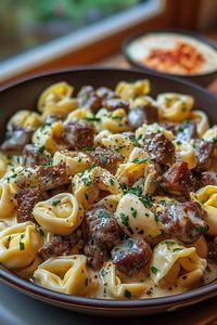 Discover the joy of making Cheesesteak Tortellini to create a perfect blend of tender tortellini, beef steak, and a rich provolone sauce.