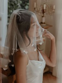 The original 'Heart Trim Veil', our beautiful handmade veil offers something different for the Bride's Bachelorette/ Hen Party or wedding day look. Handmade in London, this product takes 3 hours to make and each heart is individually attached to the end of our classic white tulle. A Gigi & Olive's favourite, this i