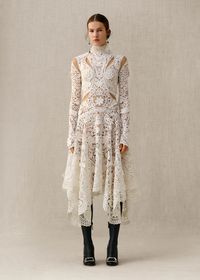 From the new Alexander McQueen Autumn/Winter 2018 pre-collection. Inspired by the British Art Nouveau style and the natural world, an ivory Irish crochet lace dress with elongated sleeves features three-dimensional flowers and tangled garlands of leaves.