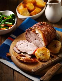 Roast shoulder of pork with crackling and cider gravy