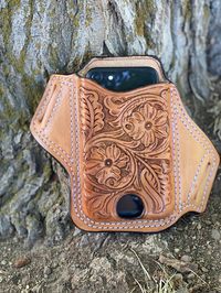 .This is a leather phone case for any cellular phone (I-Phone, Samsung, Google Pixel...) - - - NOTE: We will need the dimensions of your phone with the protective case on the phone. I need height, length and width. Just add these to your order in the NOTES section. .western floral design is hand drawn right onto the leather, so each phone case is a little different each time making them each unique in their own way. .case can also be made plain with no tooling. .can be customized with name or in