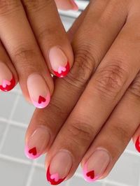 French short nails in pink and red with a heart accent