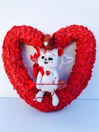 "I made this adorable, one-of-a-kind, Valentines wreath from a straw heart form, crepe paper and an Annalee, 2008, cupid mouse doll. My crepe paper wreaths are sprayed with a sealant spray and can be hung outside as long as it is covered by a portico or roof structure. This wreath is not water proof. I use a special, paper twist technique to make the crepe paper look vintage. I added the Annalee doll which was already detailed with a bag of felt, glittered arrows a bow and arrow, and a red, jewe