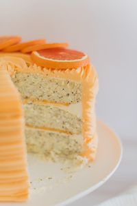 Orange Almond Poppy Seed Cake - light and fluffy poppy seed cake layers, infused with orange and almond flavoring, topped with almond buttercream and orange curd. #cakebycourtney #almondcake #almondpoppyseedcake #orangealmondpoppyseedcake #orangecurd #almondbuttercream #summercake #summerdessertrecipe #summerdessert #poppyseedcake #lightandfluffycake #cakedesign #cakerecipes #cakesforgirlsbirthday #cakeaesthetic #cakeideas #cakedecorating