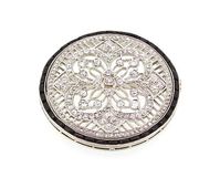 Jewellery Discovery - An exquisite circular brooch dating from the Art Deco era. This stunning brooch features a diamond-set floral and geometric design, surrounded by a halo of calibre-cut onyx. Mounted in platinum.