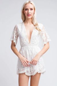 Nothing is plain about the knockout Endless Lace White Deep V Romper! Lightweight white embroidered lace fabric forms a short sleeve plunge neckline romper bodice with scalloped trimmed sleeves and shorts. Embellished in clustered lace that creates an enchanting romantic elegant look. Lined shorts and front body.