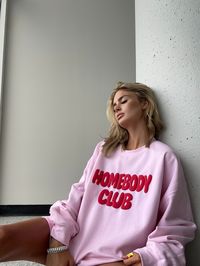 Get cozy in our Homebody Club Pink Crew! Made with a soft cotton blend, this light pink sweatshirt features a bold red 3D puff print graphic that adds a pop of color to your loungewear. Perfect for relaxing at home or running errands, this crewneck will keep you comfortable and stylish all day long.