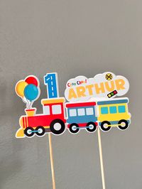 "This colorful personalized train cake topper is perfect for your train birthday party! Both name and age can be personalized. Please use the personalization box :-)  Single-sided and measures about 8\"(wide)x4.3\"(tall).  The train topper has two layers for sturdiness. The train design is printed on glossy cardstock by a Canon professional photo printer for vibrant colors; the second layer is cut out of extra heavy cardstock (120lbs/325gsm) as a backing card. Carefully designed and assembled by