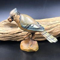 A truly lovely vintage (most likely mid-century) carved wood blue jay bird.  It's holding a little nut/seed in its beak.  When I first saw this, I immediately thought of ANRI Italy.  It's not marked but I feel pretty certain it IS ANRI.  I was able to find a sold listing for the same bird (also unmarked) and attributed to ANRI as well. It's in very nice condition with NO breakage and measures 4.25" high x 4.25" wide x 2.25" deep. The colors are muted like you see on ANRI hand-painted wood pieces.