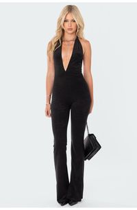 Make a striking impression in this plunge-neck jumpsuit crafted from rich velvet with an open back and wide hems. Plunge neck Halter neck Polyester/spandex Machine wash, tumble dry Imported