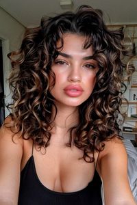 Curly haircuts are all about celebrating your texture and finding a style that complements your face shape. Whether you have loose waves, bouncy spirals, or tight coils, there’s a curly haircut out there that will