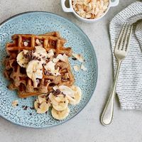 Vegan Banana Waffles! This vegan waffle recipe is easy to make and super healthy. Made with whole wheat flour, brown bananas, and flax seeds, these are perfect to keep frozen and pop into the toaster on a busy morning. #veganwafflerecipe #bananawaffles