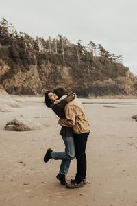 Wild and carefree engagement session at Hug Point State Park on the west coast of Oregon. Adventurous, carefree couple. Outdoor engagement photos in nature. Engagement session ideas and inspiration for adventurous couples. | Emma Halet Photography | Traveling Wedding, Elopement, and Engagement Photographer | via www.emmahalet.com