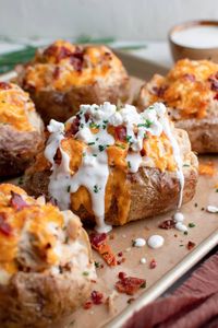 Crack Chicken Stuffed Baked Potatoes pair creamy cheddar, bacon and ranch chicken and a fluffy baked potato into one delicious meal.