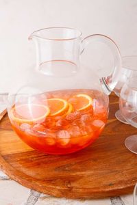 A pitcher of aperol spritz being made.